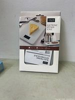 Front of boxed Thinktank Technology electronic kitchen scale