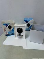 Camera in foam tray with two retail boxes visible