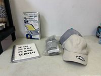 Full lot showing voice recorder box, two caps, sealed socks, notebook