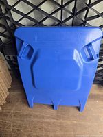 Front view of one blue recycling bin lid for size and design reference