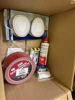 Box view showing respirator filters, duct tape roll, Toyota fluid, smaller items