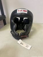 Front view of Top Ten black headgear showing logo and full face opening