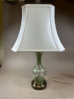 Full view of lamp showing handpainted glass base with fabric shade