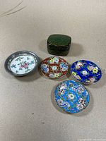 Top view of Burmese lacquer box and four Japanese porcelain plates