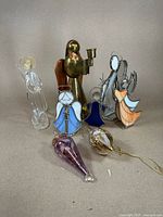 Group photo showing all angels and ornaments including stained glass, hand blown glass, brass angel, and painted ornaments.
