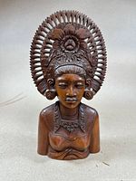 Front view showing facial features and headdress details