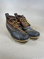 Front and side view of LL Bean Bean Boots showing the leather upper, rubber lower, and laces.