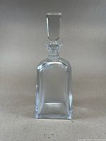 Full view of the clear rectangular crystal decanter with stopper in place.