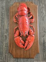 Full view of lobster sculpture on plaque