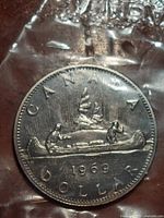 Reverse side showing Voyageur canoe design and 1969 date