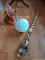 Wizard figurine, staff and excluded crystal ball on floor
