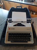 Front view of Olympia Carina 2 typewriter seated in open carrying case