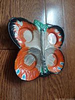 Top view of hand painted butterfly dish showing coloration and four recesses