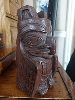 front angled view of Haida wood carving showing hawk head and wing details