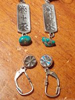 Front view showing both earring pairs: rectangular turquoise dangles and round sunburst leverbacks