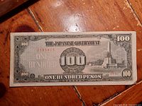 Obverse of WWII Japanese Government 100 Peso banknote showing serial number 0383815 and Rizal Monument