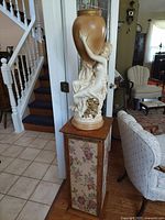 Full view showing sculpture on pedestal