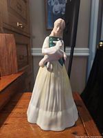 Front view of Royal Doulton Springtime figurine with woman holding goose