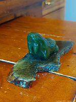 Side view of jade walrus on base