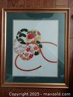 Frontal view of framed embroidery showing artwork and frame