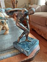 Front-left view of bronze discus thrower on marble base