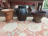 All three vases side by side on rug showing design and scale