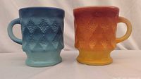 Front view of both gradient mugs showing colors and diamond texture