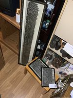 All three framed photographs leaning against furniture