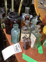 Group shot of all eight antique bottles on shelf