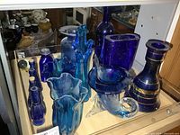 Group shot of all blue glass pieces on shelf