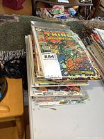 Stack of bagged Marvel comics on table
