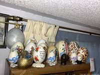 Group view of assorted decorative eggs on shelf