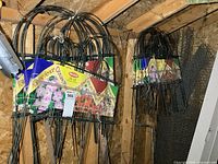 Multiple packages of folding garden fence hanging on wall
