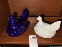 Cobalt blue porcelain and white milk glass hens on nests side by side