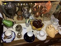 Overall lot showing teapot, bookends, copper items, cups, saucers, bowls and figurines