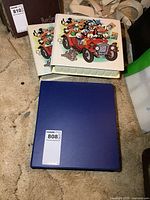 Three binders: two Disney illustrated covers, one plain blue