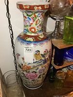 Full view of porcelain vase showing size and decorative motifs