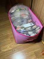 pink fabric bin filled with plastic sleeves of matchbooks