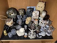 Full shelf view showing majority of owl figurines