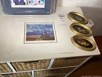 All four art pieces on cabinet top