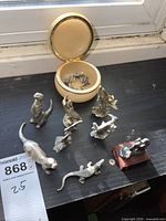 Group shot of pewter figurines, trinket box open