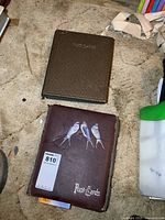 Closed albums showing covers and wear