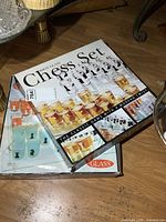 Two boxed shot glass chess sets stacked