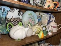 Overview of teapots and plates on shelf