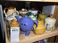 Shelf showing multiple teapots assorted colors