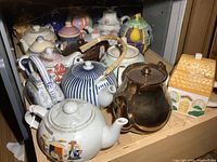 Overview of shelf showing majority of teapot collection