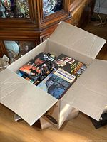 Open box showing assortment of VHS tapes