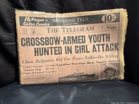 Front page in plastic sleeve showing headline, price and comics banner