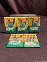 Front view of five sealed 1990-91 O-Pee-Chee Hockey wax packs