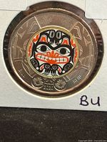 Reverse of 2020 coloured Bill Reid $2 coin in holder